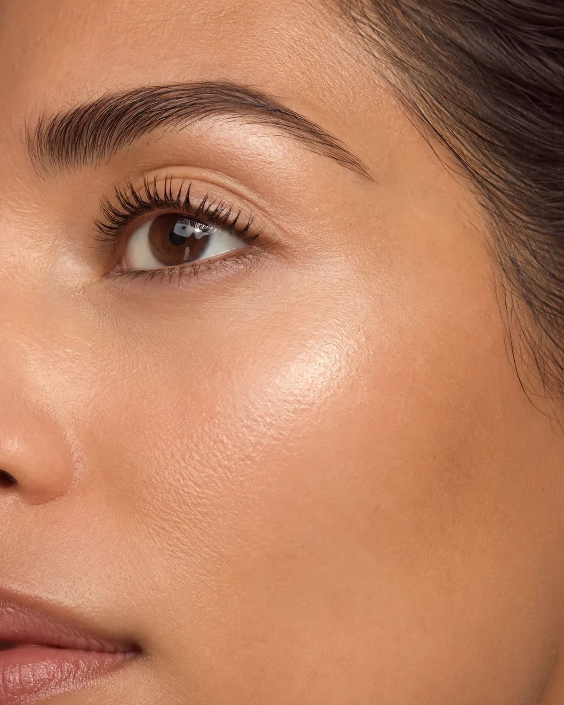 Bright close-up eye detail with luminous skin and clean brow structure
